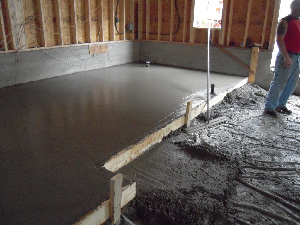 Concrete slab being poured during residential construction