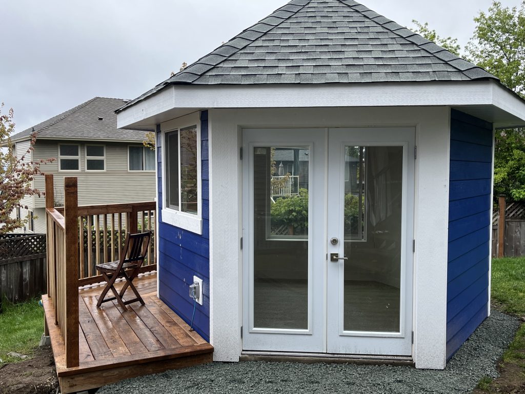 Custom blue backyard structure with wood deck built by Mad Oak Inc.