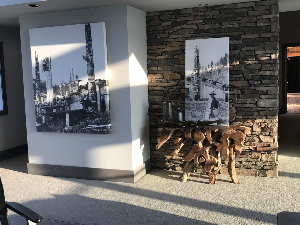 Custom stone feature wall with rustic wood console and artwork